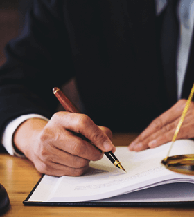 Illustrative photo of a person signing a paper